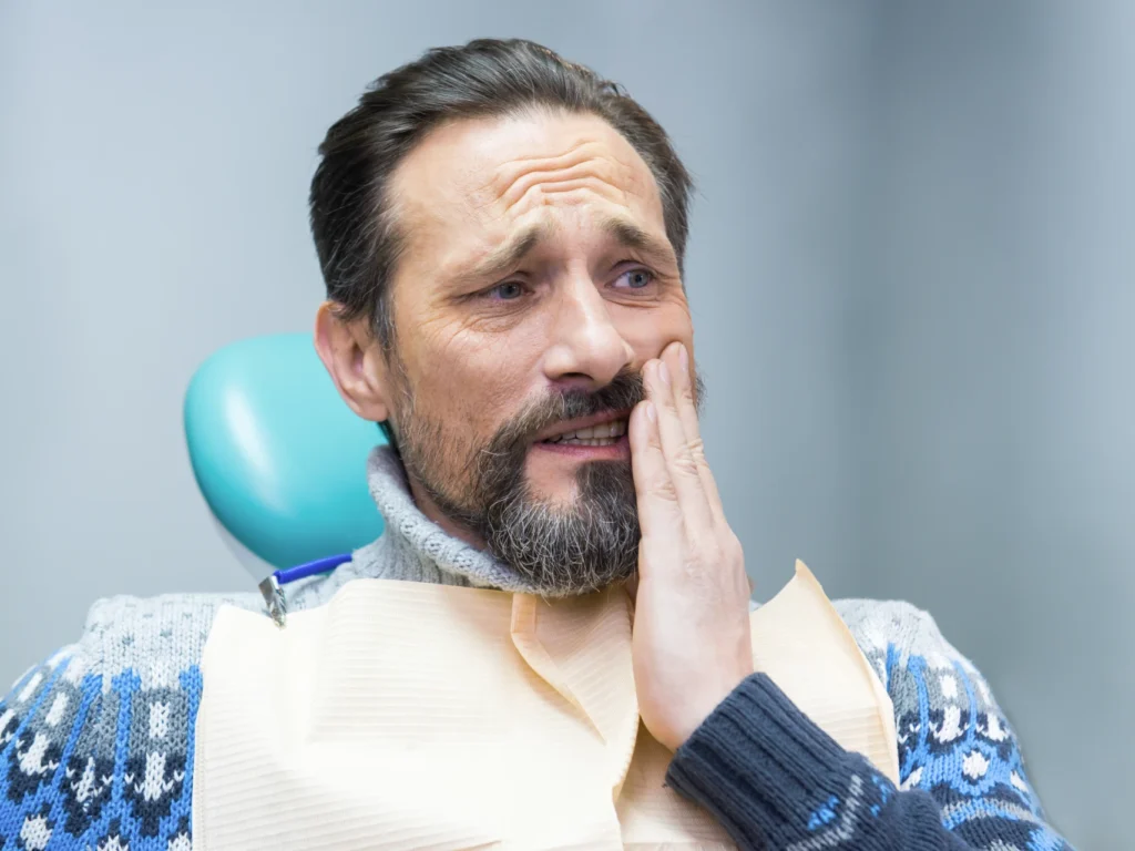 man with tooth pain | emergency dentist Deep River, CT