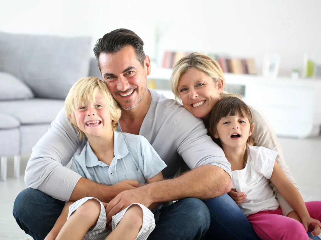 young family smiling together: comprehensive dentist in Deep River, CT